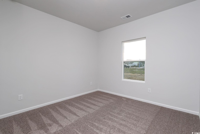 unfurnished room featuring carpet