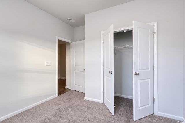 unfurnished bedroom featuring a closet and carpet