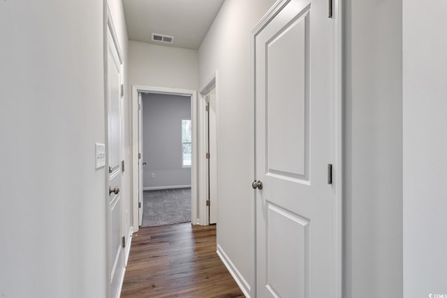 hall with dark wood-type flooring