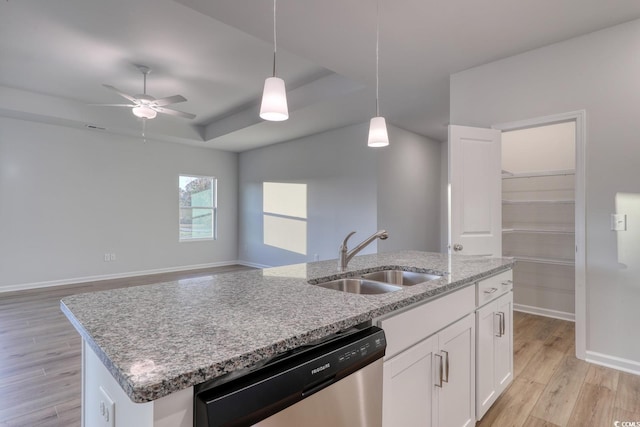 kitchen featuring white cabinets, sink, decorative light fixtures, dishwasher, and light hardwood / wood-style floors