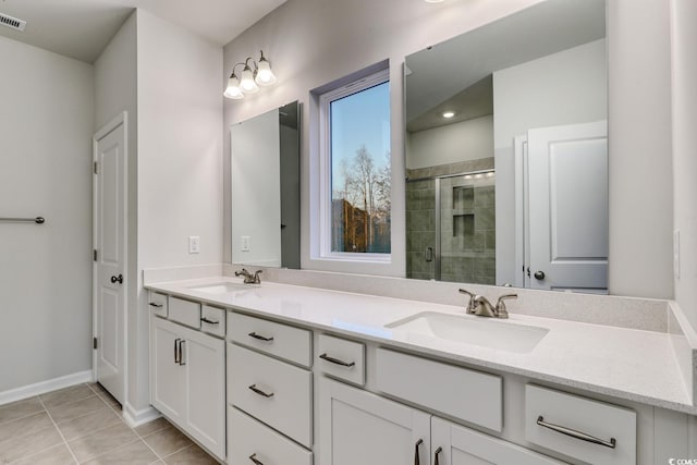 bathroom with tile patterned flooring, vanity, and a shower with shower door