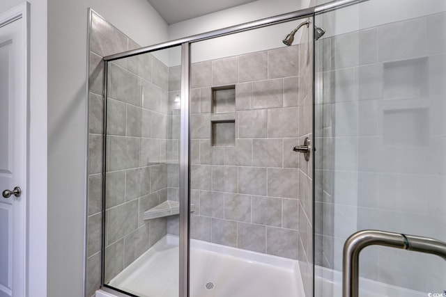 bathroom featuring a shower with door