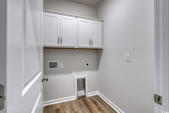 laundry room featuring electric dryer hookup, cabinets, hookup for a washing machine, and wood-type flooring