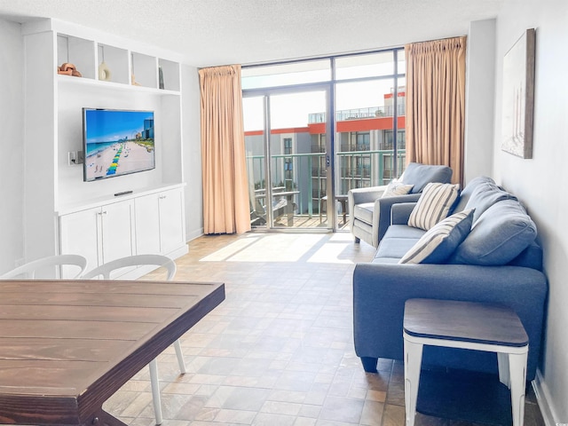 living room featuring a textured ceiling, plenty of natural light, built in features, and a wall of windows