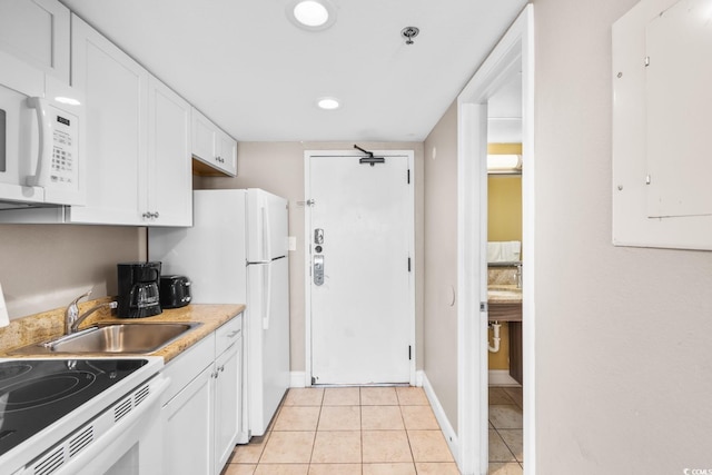 kitchen featuring white appliances, white cabinetry, electric panel, and light tile patterned floors