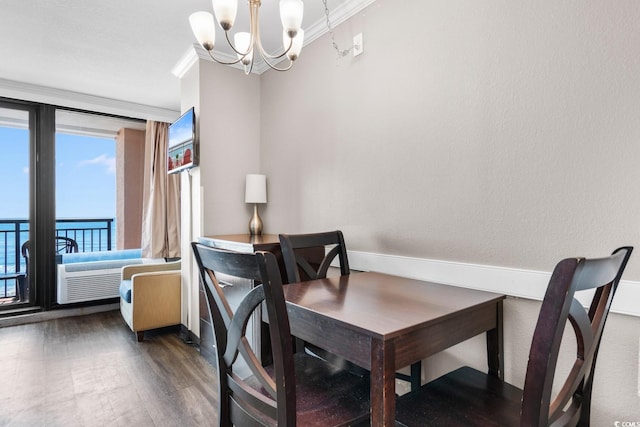 dining room featuring dark hardwood / wood-style flooring, a chandelier, and crown molding