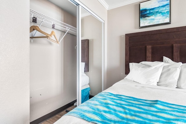 bedroom with a closet, crown molding, and dark hardwood / wood-style flooring