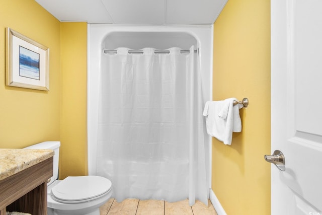 bathroom featuring curtained shower, vanity, toilet, and tile patterned floors