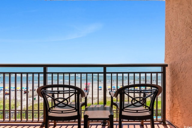 balcony with a view of the beach and a water view