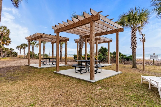 exterior space featuring a pergola, a water view, and a patio area