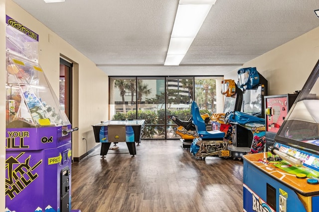 game room featuring dark hardwood / wood-style floors and expansive windows