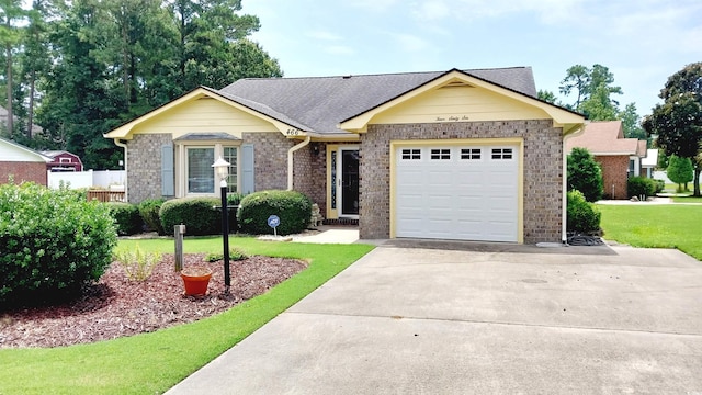 ranch-style home featuring a front lawn and a garage