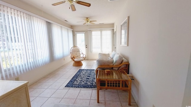 sunroom / solarium featuring ceiling fan