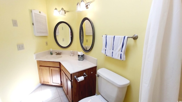 bathroom featuring toilet, tile patterned floors, and vanity