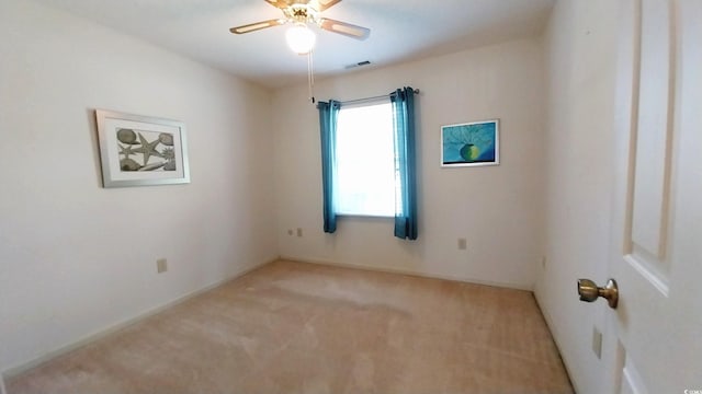 unfurnished room with ceiling fan and light colored carpet