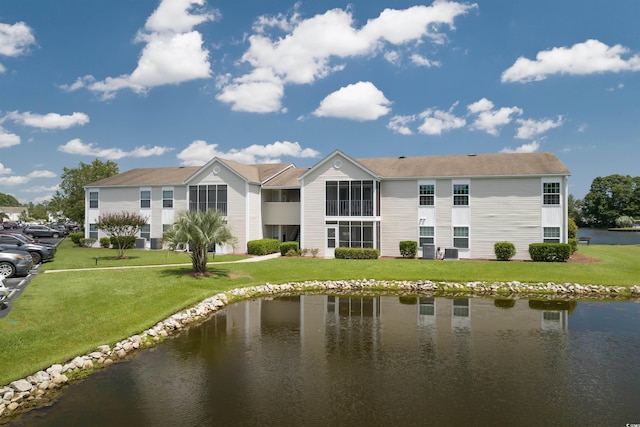 rear view of property featuring a yard and a water view