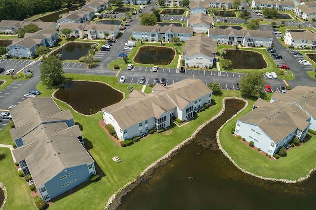 drone / aerial view featuring a residential view and a water view