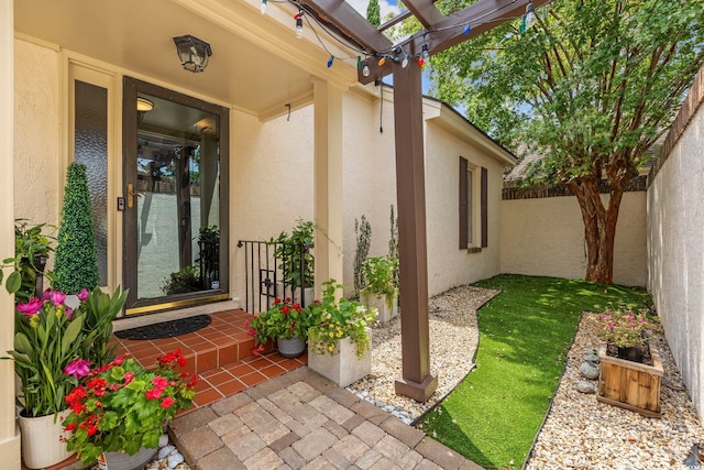 entrance to property with a pergola