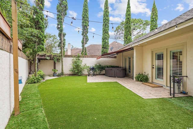 view of yard with a hot tub and a patio