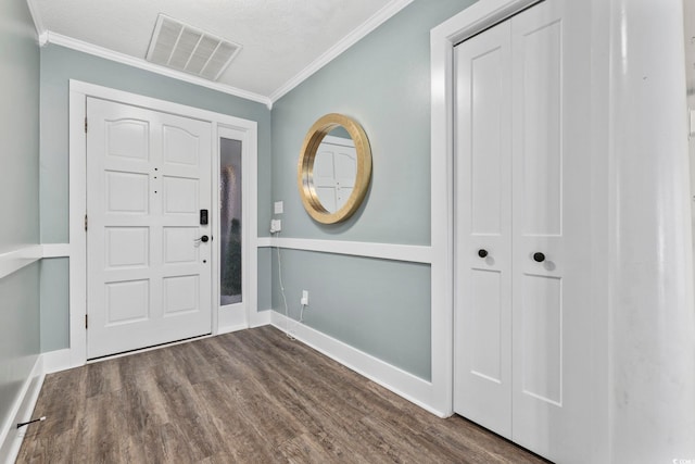 entrance foyer with dark hardwood / wood-style flooring, crown molding, and a textured ceiling