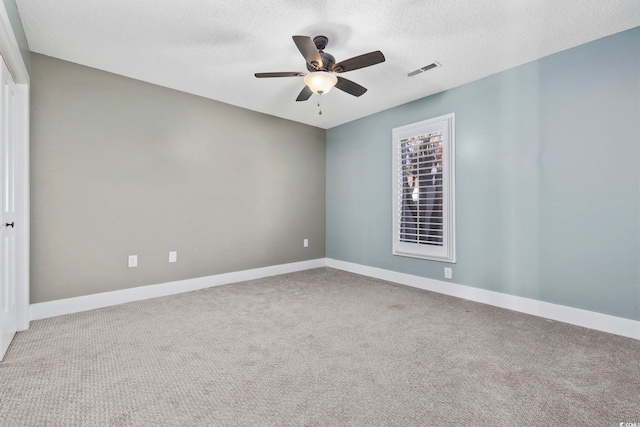 empty room featuring carpet, ceiling fan, and a textured ceiling