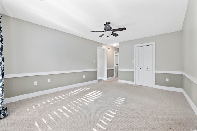 spare room featuring carpet and ceiling fan