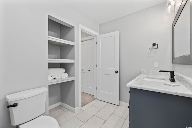 bathroom featuring toilet, tile patterned flooring, and vanity