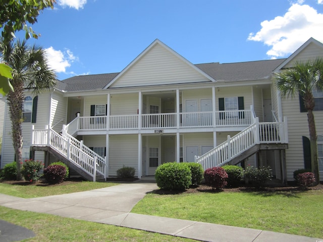 view of building exterior with driveway and stairway