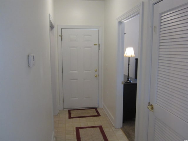 entryway featuring light floors and baseboards