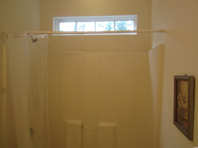 full bath with plenty of natural light and a shower with shower curtain