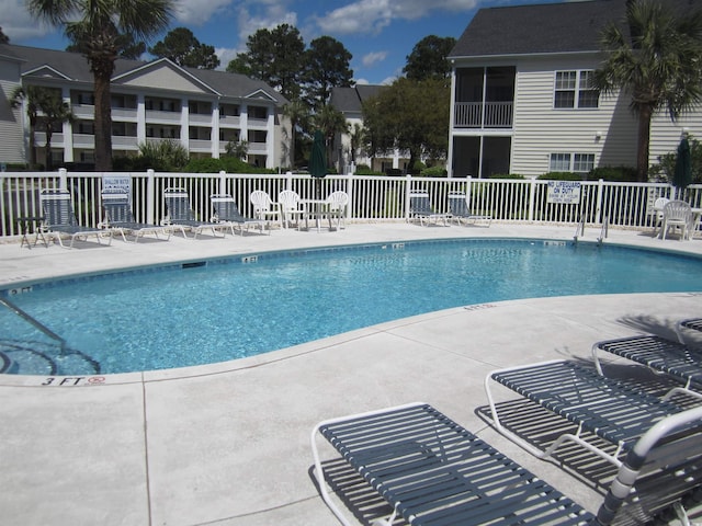 pool featuring a patio and fence