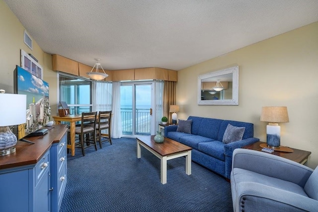 carpeted living room with a textured ceiling