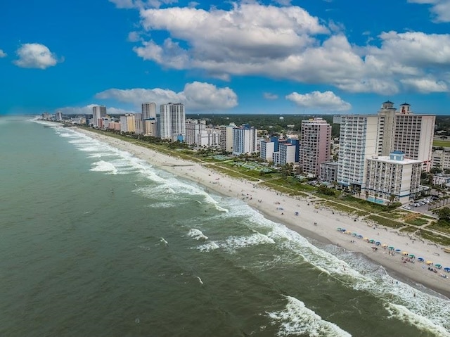 drone / aerial view with a beach view and a water view