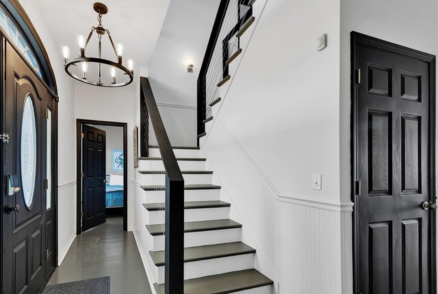 entryway with a notable chandelier and a high ceiling