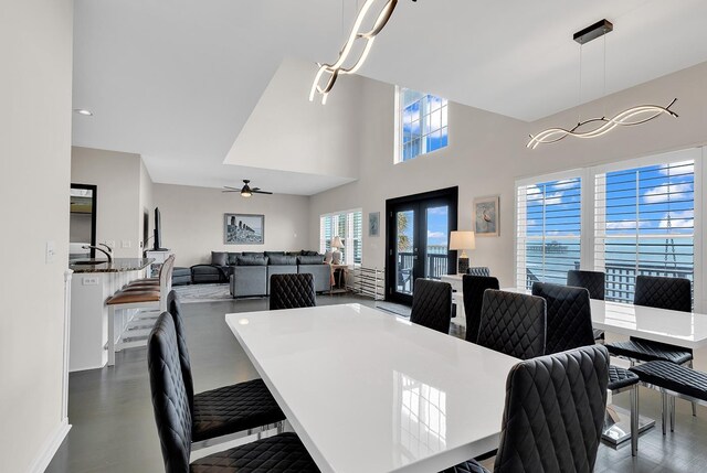 dining area with ceiling fan and french doors