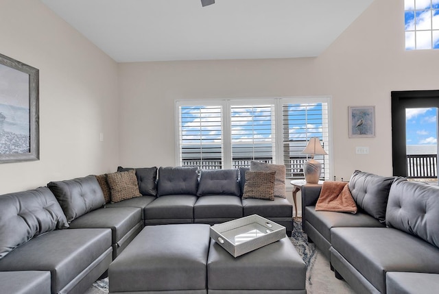 living area featuring lofted ceiling and plenty of natural light