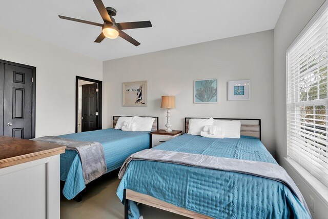 bedroom featuring ceiling fan and carpet