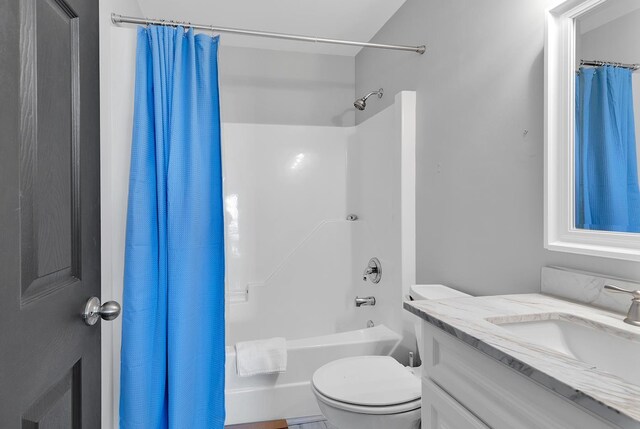 full bathroom featuring toilet, shower / tub combo with curtain, and vanity