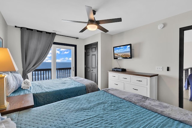 bedroom with ceiling fan, visible vents, and access to exterior