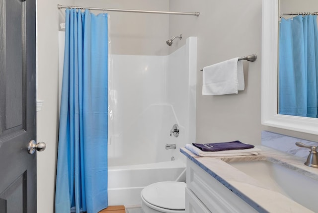 full bathroom with vanity, shower / bath combo with shower curtain, and toilet