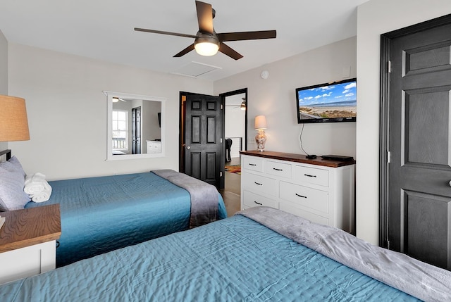 bedroom with attic access and a ceiling fan