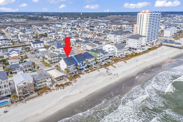 aerial view featuring a view of city, a beach view, and a water view