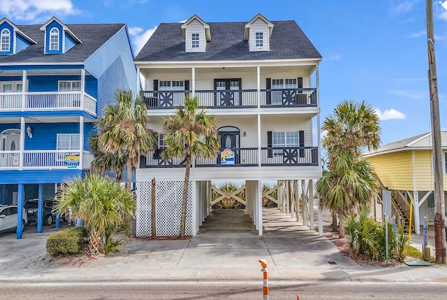 raised beach house with a balcony and a carport