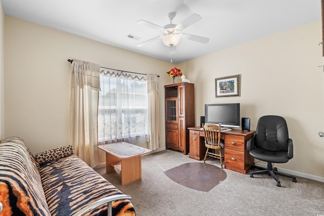 carpeted office featuring ceiling fan