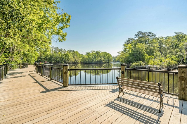 wooden terrace featuring a water view