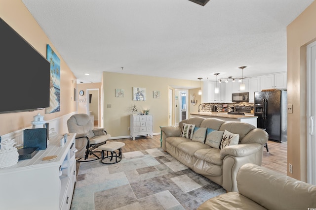 living room with sink and light hardwood / wood-style flooring