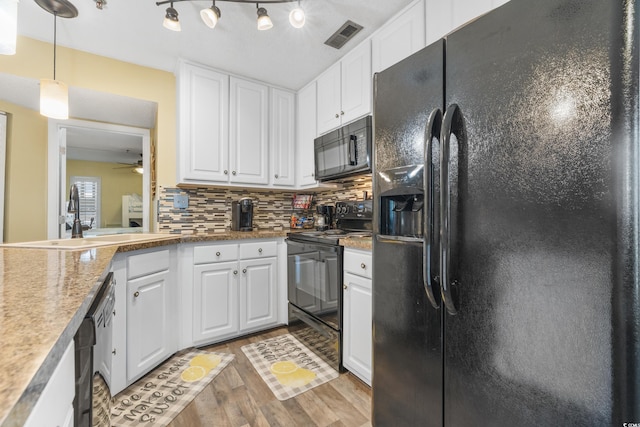 kitchen featuring backsplash, light hardwood / wood-style flooring, black appliances, track lighting, and ceiling fan