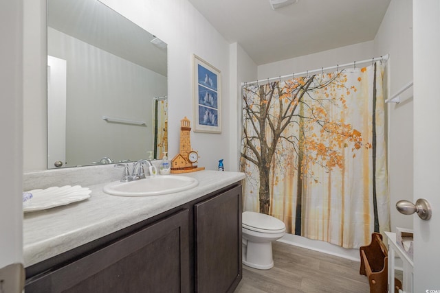 bathroom with toilet, vanity, hardwood / wood-style floors, and a shower with shower curtain