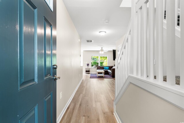 hall with light hardwood / wood-style floors