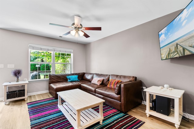 living room featuring ceiling fan and light hardwood / wood-style floors